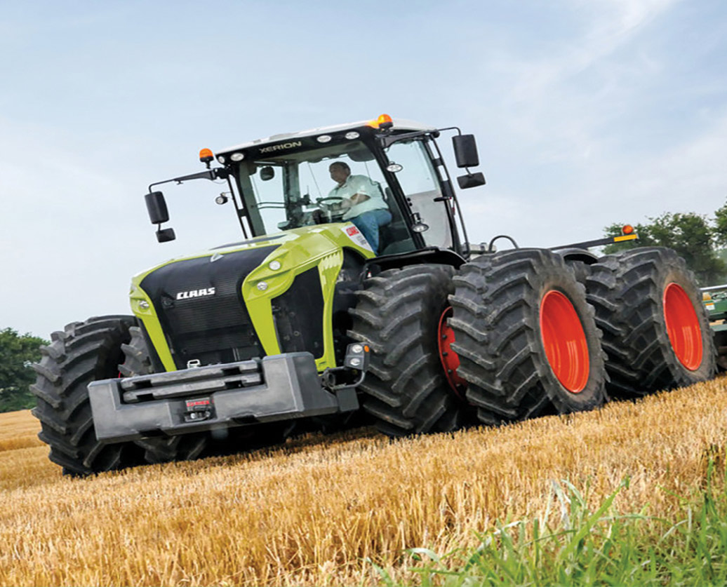Eight wheel Claas Xerion tractor working field